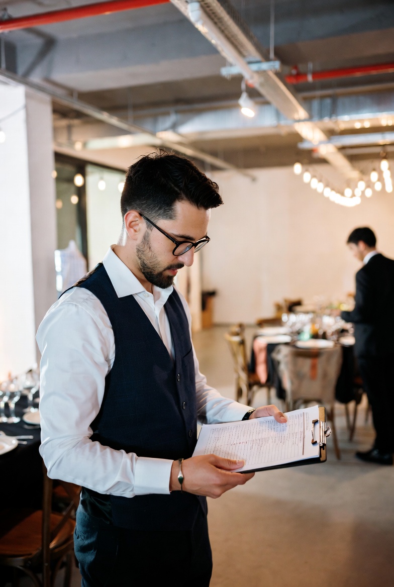 Event supervisor in Toronto holding a checklist to oversee seamless event coordination and staff management with Culinary Search Group